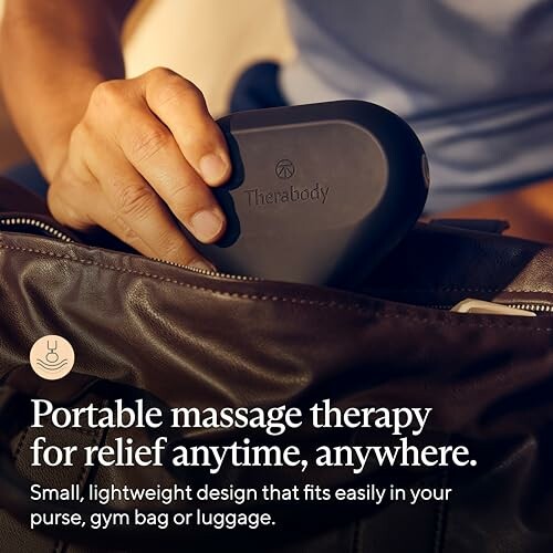 Person placing a portable massage device into a bag.